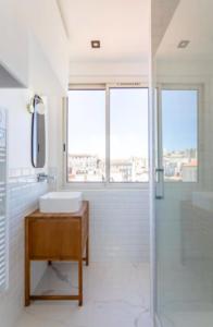 a white bathroom with a sink and a shower at STUDIO ** ROOFTOP ** LULLI in Marseille