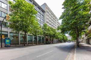 una calle urbana vacía con árboles y edificios en Bravissimo Afra, 2-bedroom apartment, en Girona
