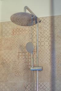a shower with a shower head in a bathroom at Holiday Home Lož in Stari Trg pri Ložu