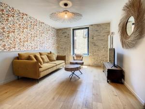 a living room with a couch and a table at La Galerie in Saint-Alban-de-Roche