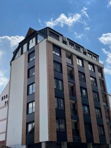 a tall building with a blue sky in the background at Avram in Zlatibor