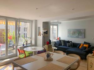 a living room with a couch and a table at La Casa Victoria -Stanislas area -Suite 65m2 OR Loft 75m2 in Nancy