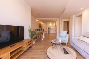 a living room with a large flat screen tv at Bravissimo Domènica, 2 bedrooms and balcony in Girona