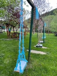 a playground with blue swings in a park at Abant Yeşil Vadi Koç Pansiyon in Dereceören