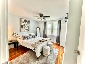 a bedroom with a bed and a ceiling fan at Hip & Spacious 3BR w/ FirePit & Large Yard in Knoxville