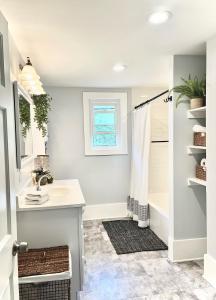 a bathroom with a sink and a shower at Hip & Spacious 3BR w/ FirePit & Large Yard in Knoxville