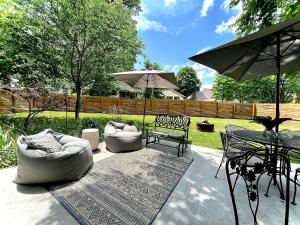 a patio with two couches and a table and chairs at Hip & Spacious 3BR w/ FirePit & Large Yard in Knoxville