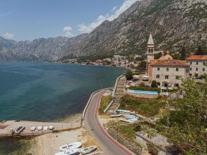 a town on the shore of a body of water at Kamena Palata Apartments in Kotor