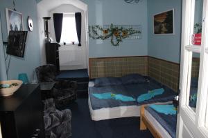een slaapkamer met een bed en een stoel bij Hotel Corrado in Ostrava
