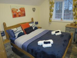a bedroom with a bed with towels on it at The Tack Room at Eastmoor Farm in Bridlington