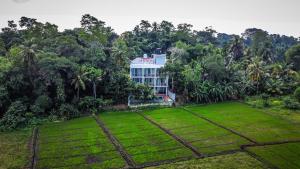 an aerial view of a house in the middle of a field at Green Edge Villa in Hikkaduwa