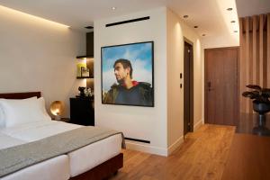 a bedroom with a large picture of a man on the wall at Teight Hotel in Thessaloniki
