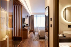a hotel room with a bed and a bathroom at Teight Hotel in Thessaloniki
