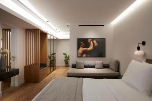 a living room with a bed and a couch at Teight Hotel in Thessaloniki