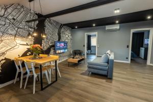 a dining room and living room with a table and chairs at Black & White in Wadowice