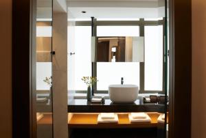 a bathroom with a sink and a mirror at Teight Hotel in Thessaloniki
