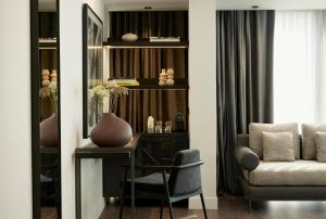 a living room with a desk and a chair at Teight Hotel in Thessaloniki