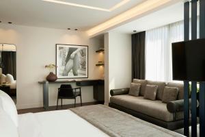 a living room with a couch and a table at Teight Hotel in Thessaloniki