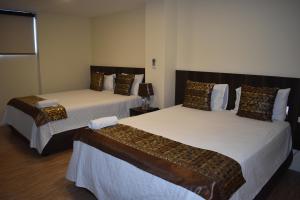 Un pat sau paturi într-o cameră la HOTEL OCEANIK