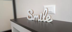 a sign that says smile sitting on top of a dresser at Tajna037 in Kruševac