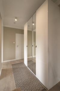 a bathroom with a walk in shower and a glass door at Apartbaltic - Monte Cassino in Świnoujście