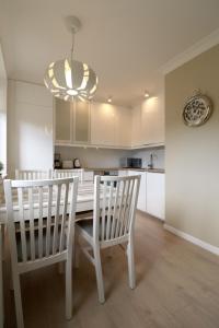 a kitchen with a table and two chairs and a dining room at Apartbaltic - Monte Cassino in Świnoujście +12 photos