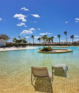 a beach area with chairs and umbrellas at AP Cabanas Beach & Nature - Adults Friendly in Cabanas de Tavira