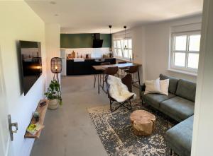 a living room with a couch and a table at Nordic Huus in Butjadingen