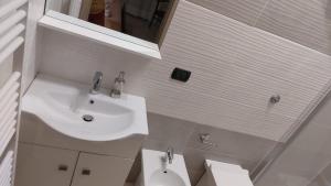 a white bathroom with a sink and a toilet at B&B L'agrumeto in Nocera Inferiore +39 photos