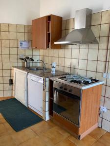 a kitchen with an oven and a sink and a stove at Casa Le Cicale in Porto Istana