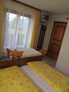 a hotel room with two beds and a window at Haus Bergfried in Westendorf