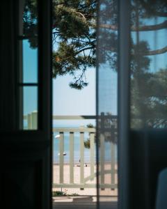 a view of the beach from a window at Hôtel Hemen in Saint-Palais-sur-Mer