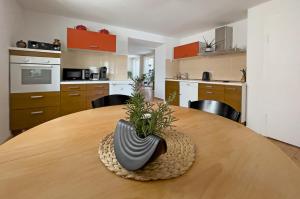 a kitchen with a wooden table with a vase on it at Lieselhaus in Busenberg