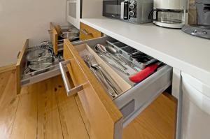 a kitchen with an open drawer with utensils at Lieselhaus in Busenberg