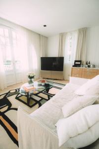 a living room with a large bed and a table at Hôtel Hemen in Saint-Palais-sur-Mer