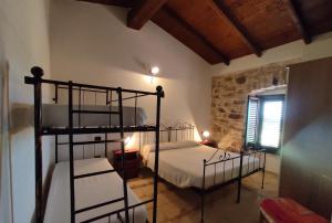 A bed or beds in a room at Agriturismo Gragonti, Arbus Costa Verde Még 14 kép