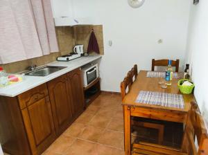 a kitchen with a table and a sink and a table and a tablektop at Aris Seaside Issos Beach in Agios Georgios