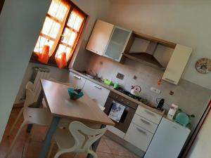 a small kitchen with a wooden table and a counter top at La casetta di Bianca in Riccò del Golfo di Spezia +70 photos