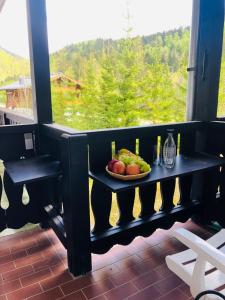 a plate of fruit on a table on a balcony at Ferienwohnung Lofereck in Reit im Winkl