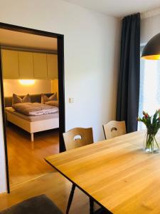 a dining room with a table and a bed at Ferienwohnung Lofereck in Reit im Winkl