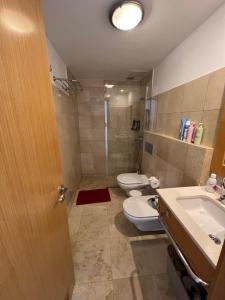 a bathroom with two toilets and a sink and a shower at Pearl Apartment Corralejo in Corralejo