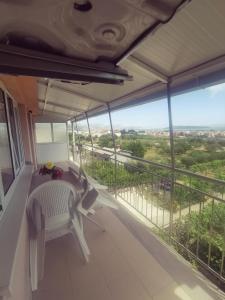 a balcony with a table and chairs and a view at Apartment Jope in Kaštela
