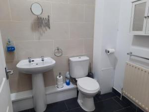 a bathroom with a white toilet and a sink at Alexander Apartments South Tyneside 2 in South Shields
