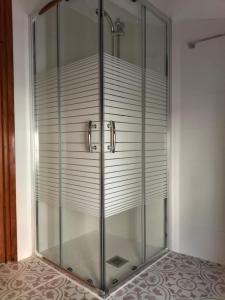 a glass shower stall in a room at Casa Garí in Horta de San Joan