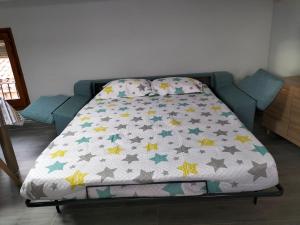 a bed with a comforter with stars on it at Casa Garí in Horta de San Joan