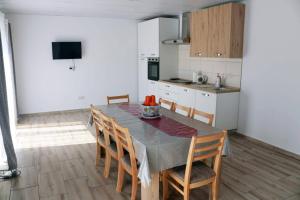a kitchen and dining room with a table and chairs at Nature House Bulgaria in Radanovo