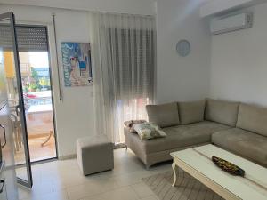 a living room with a couch and a table at Diar Apartment in Durrës