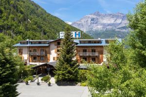 a hotel with a view of a mountain at Fontaine du Mont Blanc Hotel & Spa in Les Houches