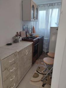 a kitchen with a stove and a counter top at Casa Dorina 2 in Techirghiol +6 photos
