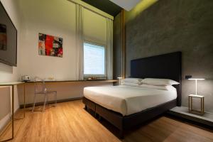 a bedroom with a large bed and a window at Maison Pellegrino in Rome